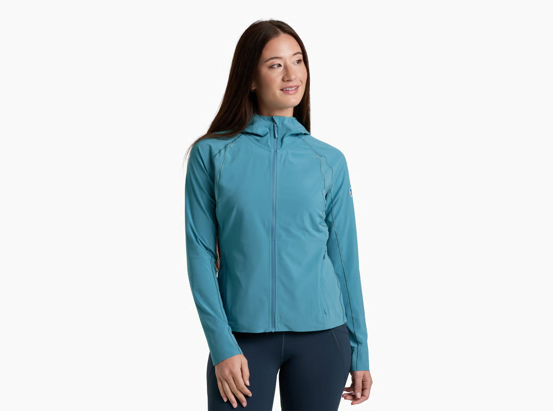 Woman wearing a teal jacket on a white background