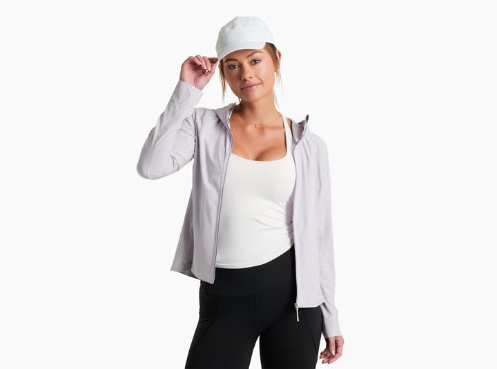 Woman wearing a light gray jacket, white top, and black pants on a white background