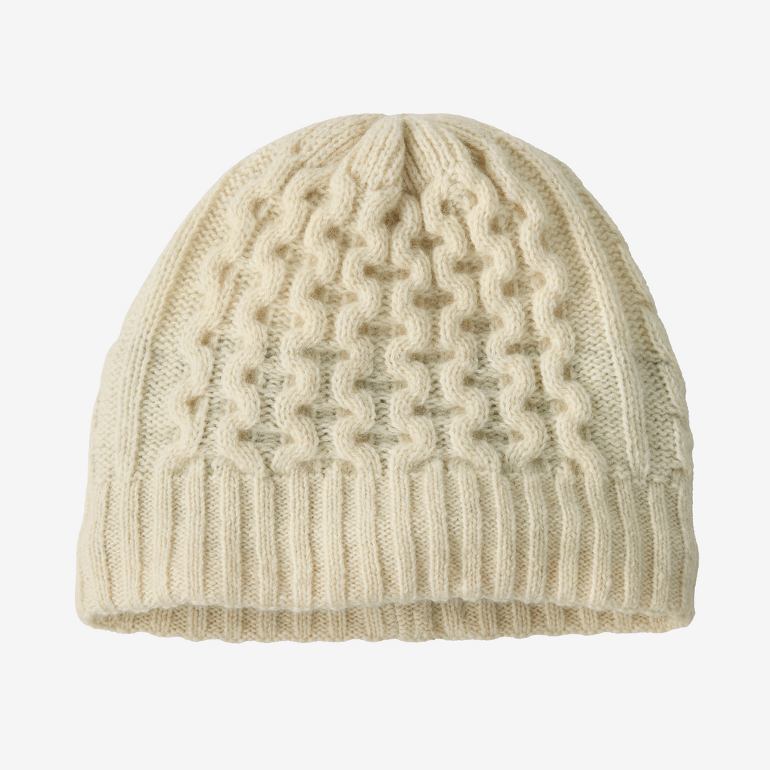Cream knit beanie on a white background.