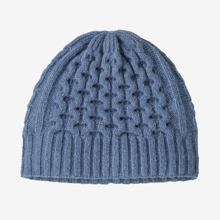 Blue knitted beanie with a pattern on a white background
