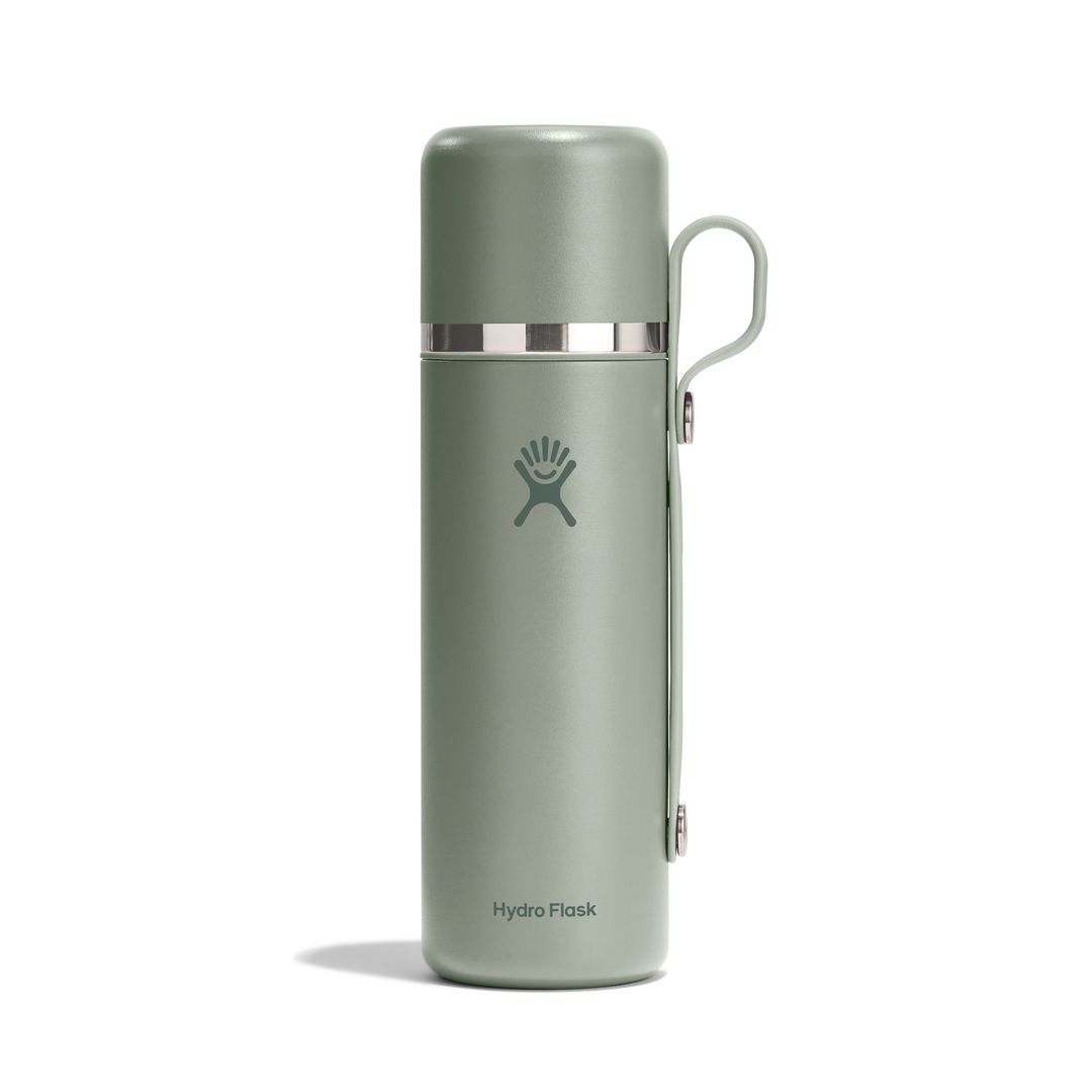 Matcha green thermos bottle with Hydro Flask logo and a carry strap on a white background