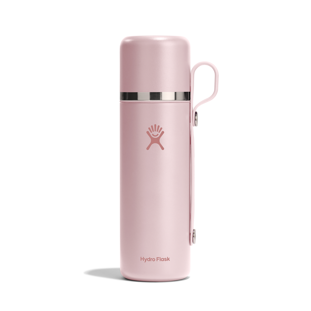 Pink thermos bottle with Hydro Flask logo and a carry strap