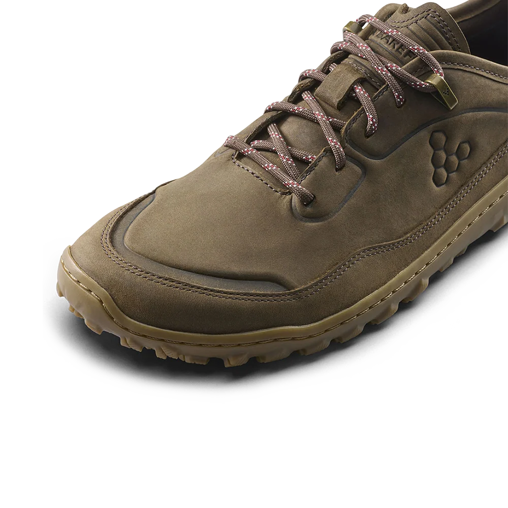 A single brown suede lace-up shoe shown at a three-quarter angle on a clean white background. The shoe features a textured brown upper, brown laces with a subtle pattern, a tan outsole, and a debossed logo on the side.