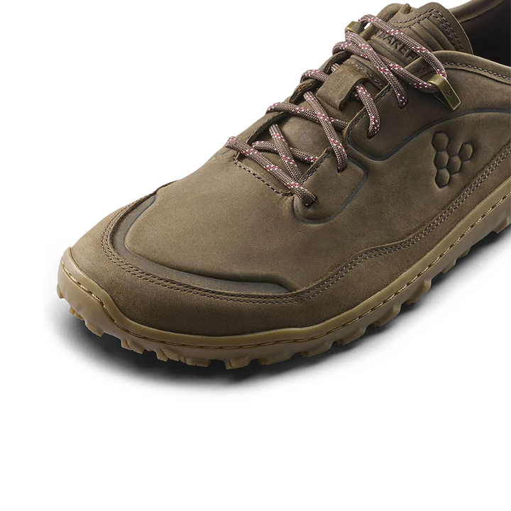 A single brown suede lace-up shoe shown at a three-quarter angle on a clean white background. The shoe features a textured brown upper, brown laces with a subtle pattern, a tan outsole, and a debossed logo on the side.