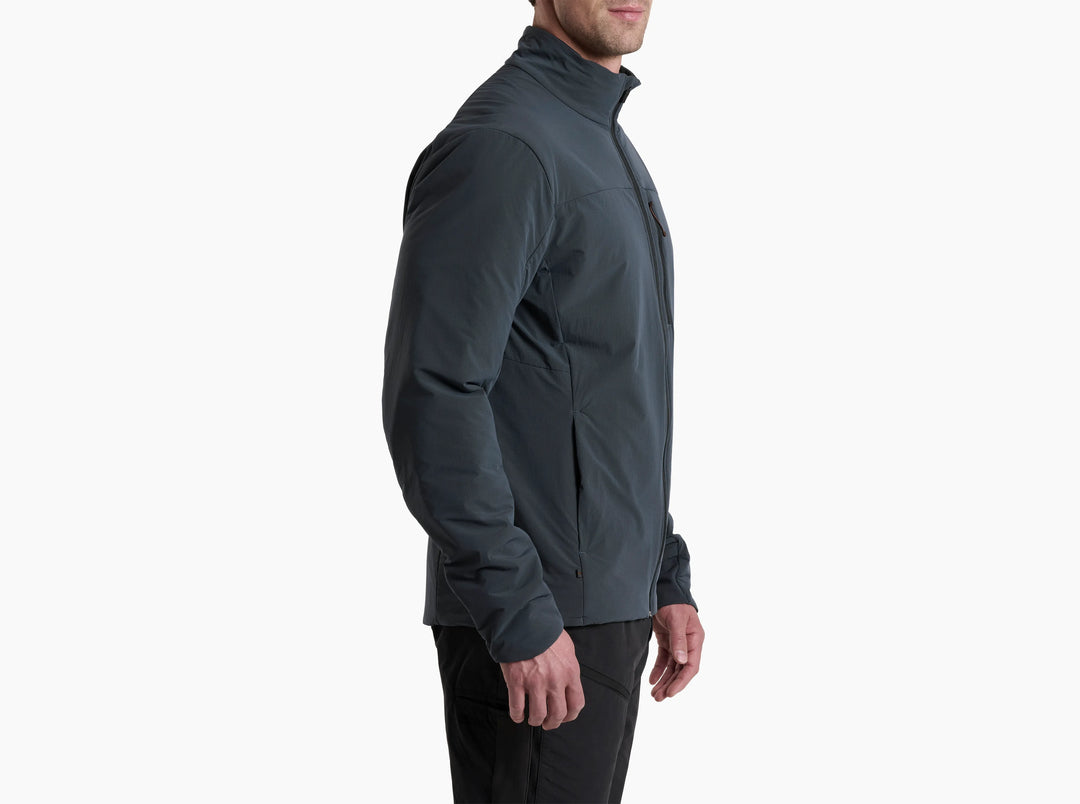 Man in a black jacket standing side on to the camera on a white background