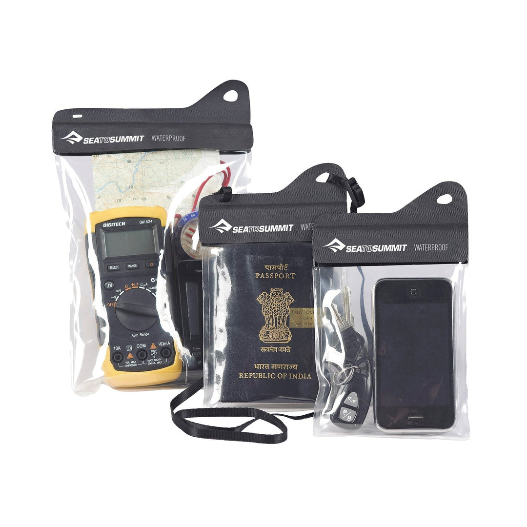 Set of Sea to Summit waterproof accessory cases with electronic devices and a passport
