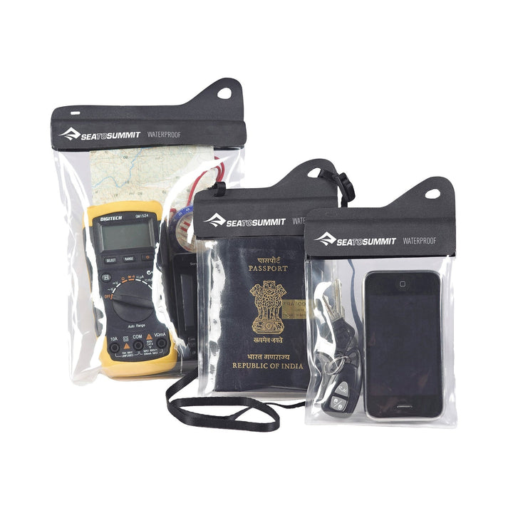 Set of Sea to Summit waterproof accessory cases with electronic devices and a passport