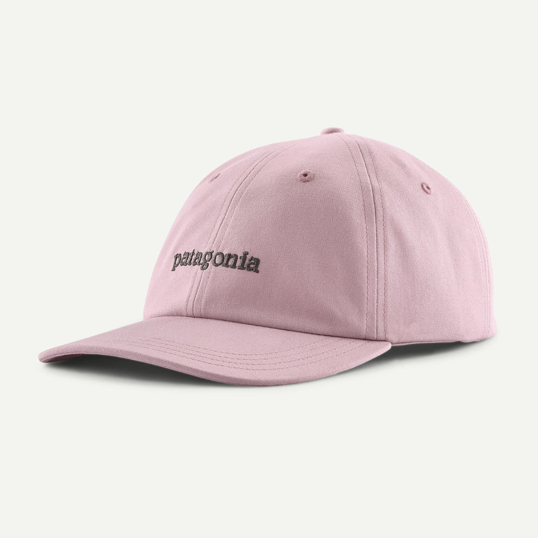 Pink baseball style cap with brown patagonia branding on a white background