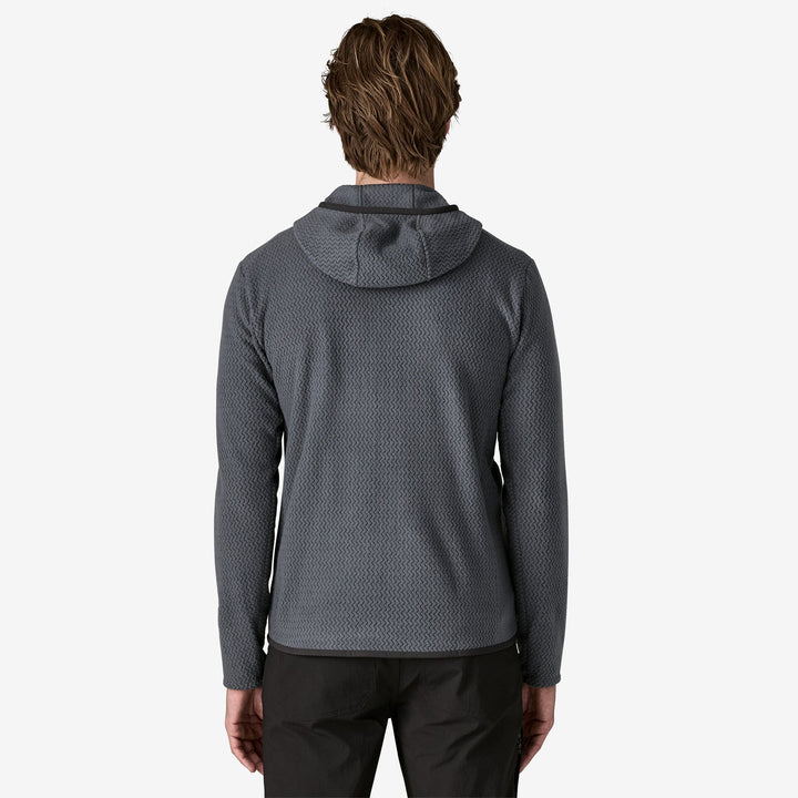Person wearing a grey fleece hoodie on a white background