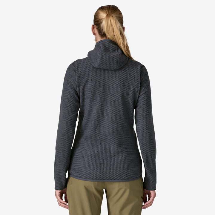 Back view of woman wearing dark grey hooded fleece, on a white background