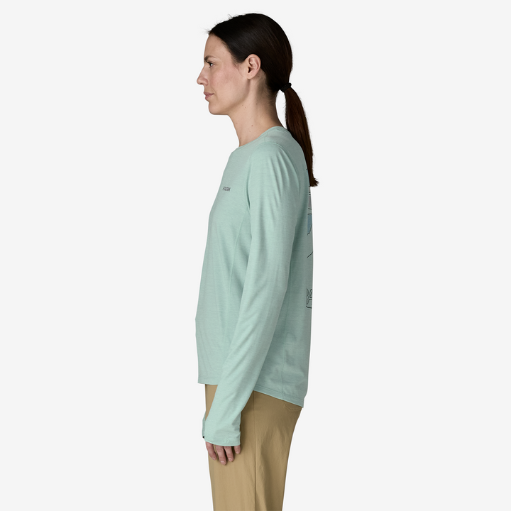 Woman wearing a light green long-sleeve shirt on a white background