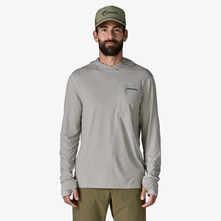 Man wearing a gray hoodie with a patagonia logo on a white background