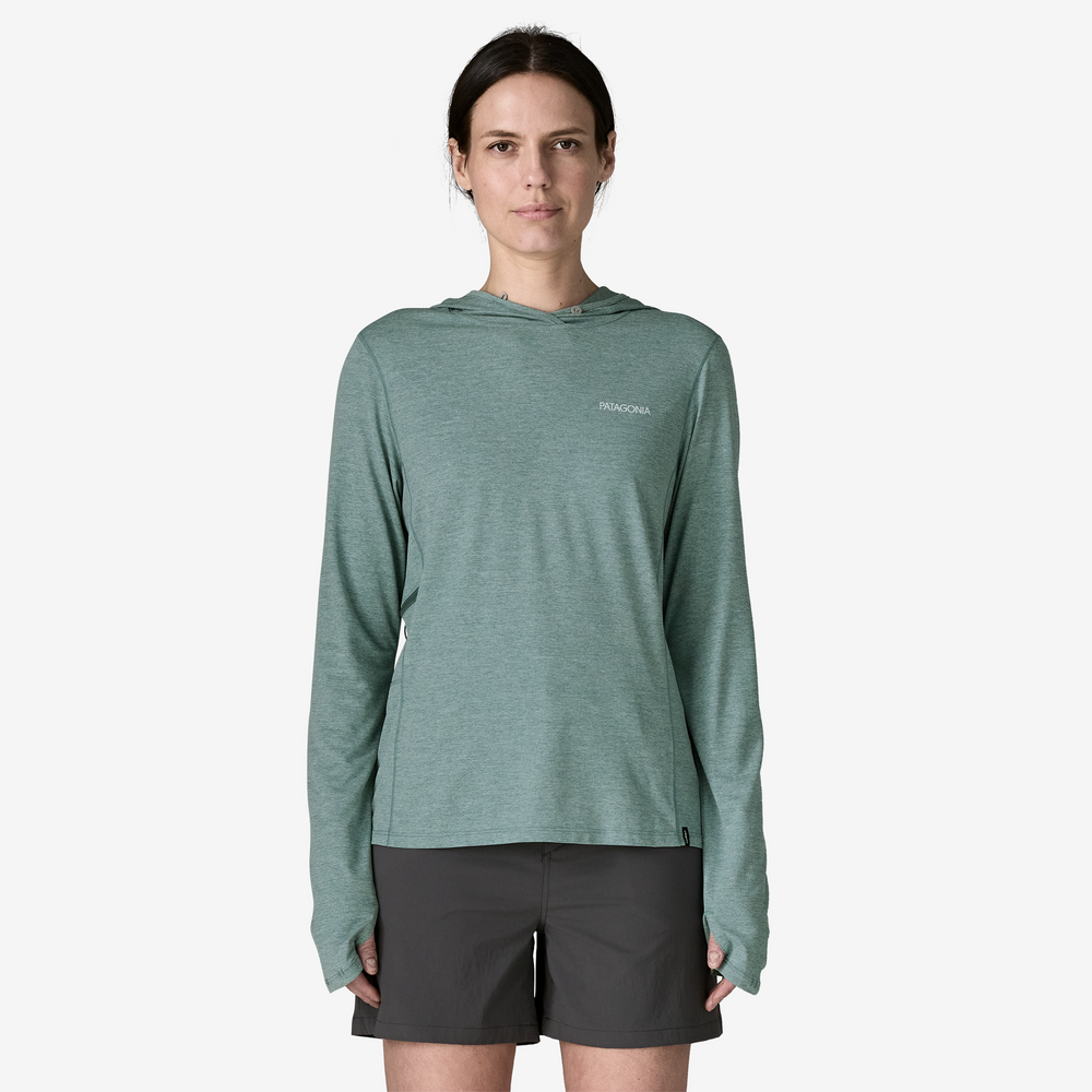 Woman wearing a green long-sleeve hoodie with a brand logo on a white background