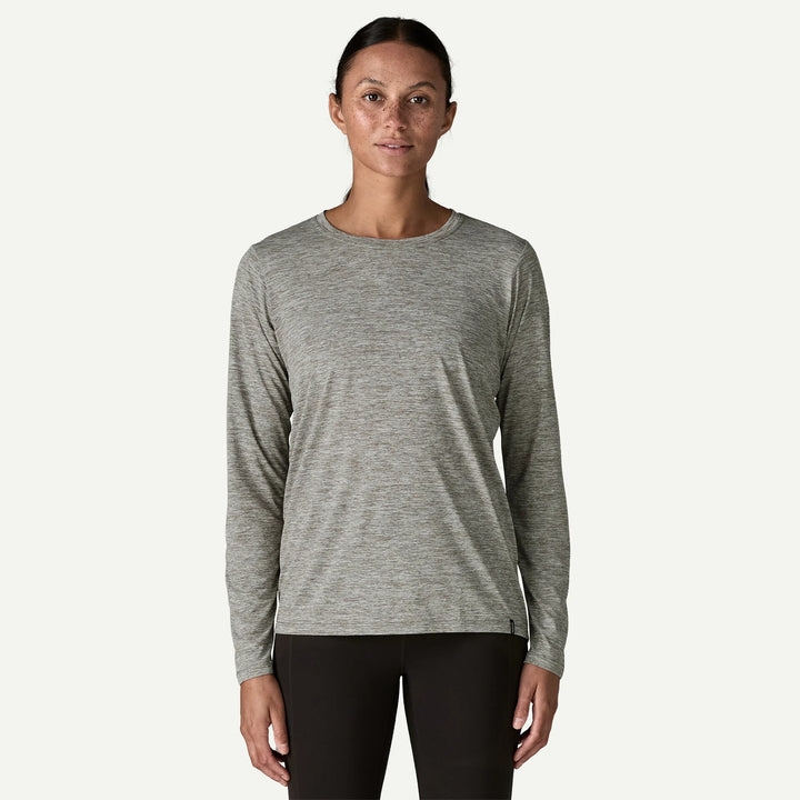Woman wearing a gray long-sleeve shirt on a white background