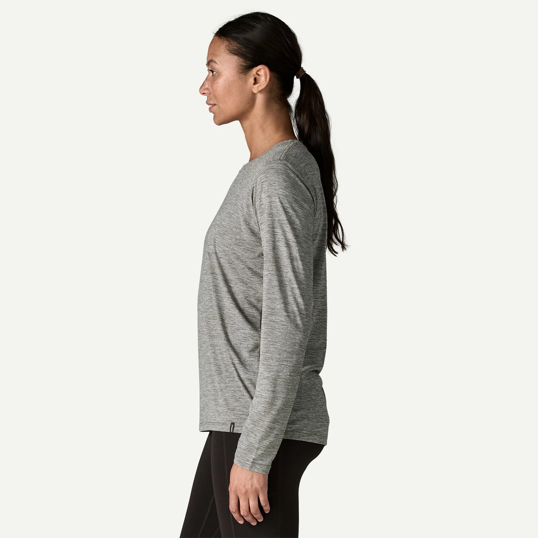 Woman wearing a gray long-sleeve shirt on a white background
