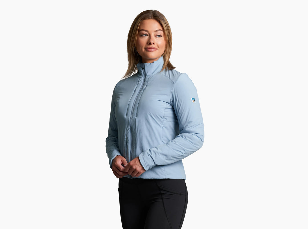 Woman wearing a light blue jacket and black leggings on a white background
