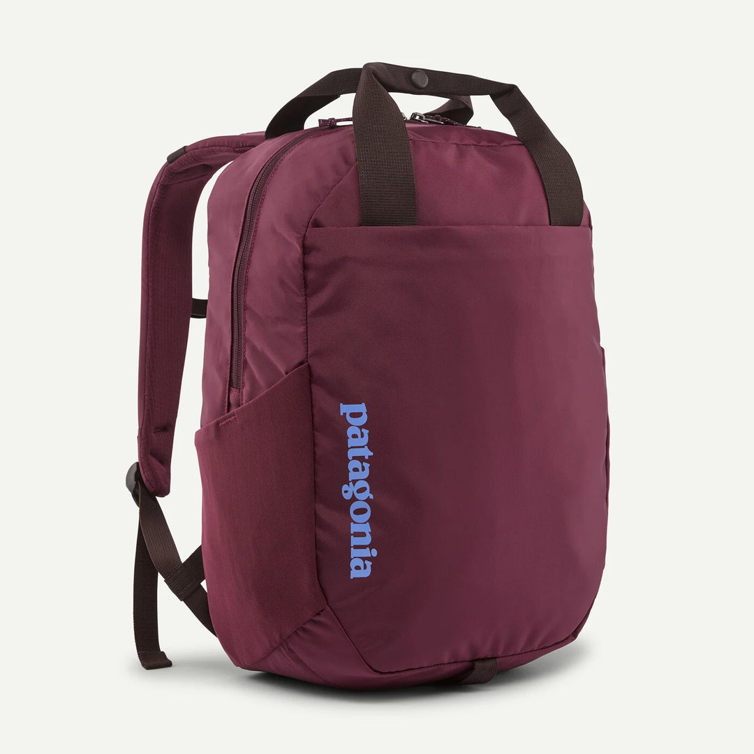 A Patagonia backpack in burgundy with dark brown handles and straps, featuring a vertical blue Patagonia logo on the front pocket, set against a light gray background.