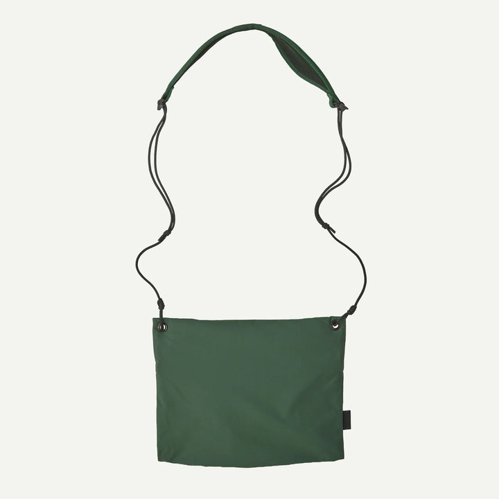 A dark green canvas shoulder bag with an adjustable, detachable black cord strap, shown against a plain white background.