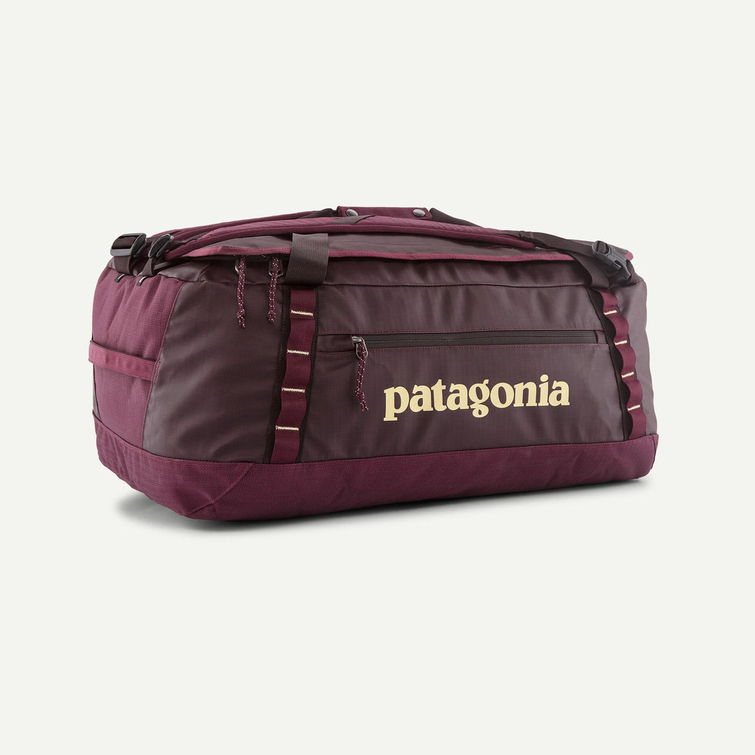 A Patagonia duffel bag in maroon and dark gray with a gold Patagonia logo on the front, shown on a plain white background.