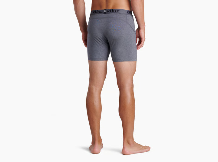 A man modeling light gray heathered boxer briefs with a black waistband featuring the KUHL logo, shown against a plain white background.