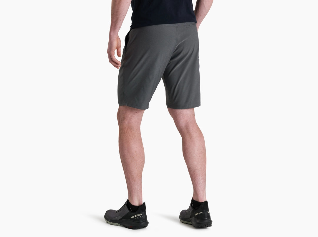 Person wearing gray shorts on a white background