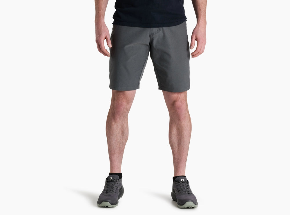 Person wearing gray shorts on a white background