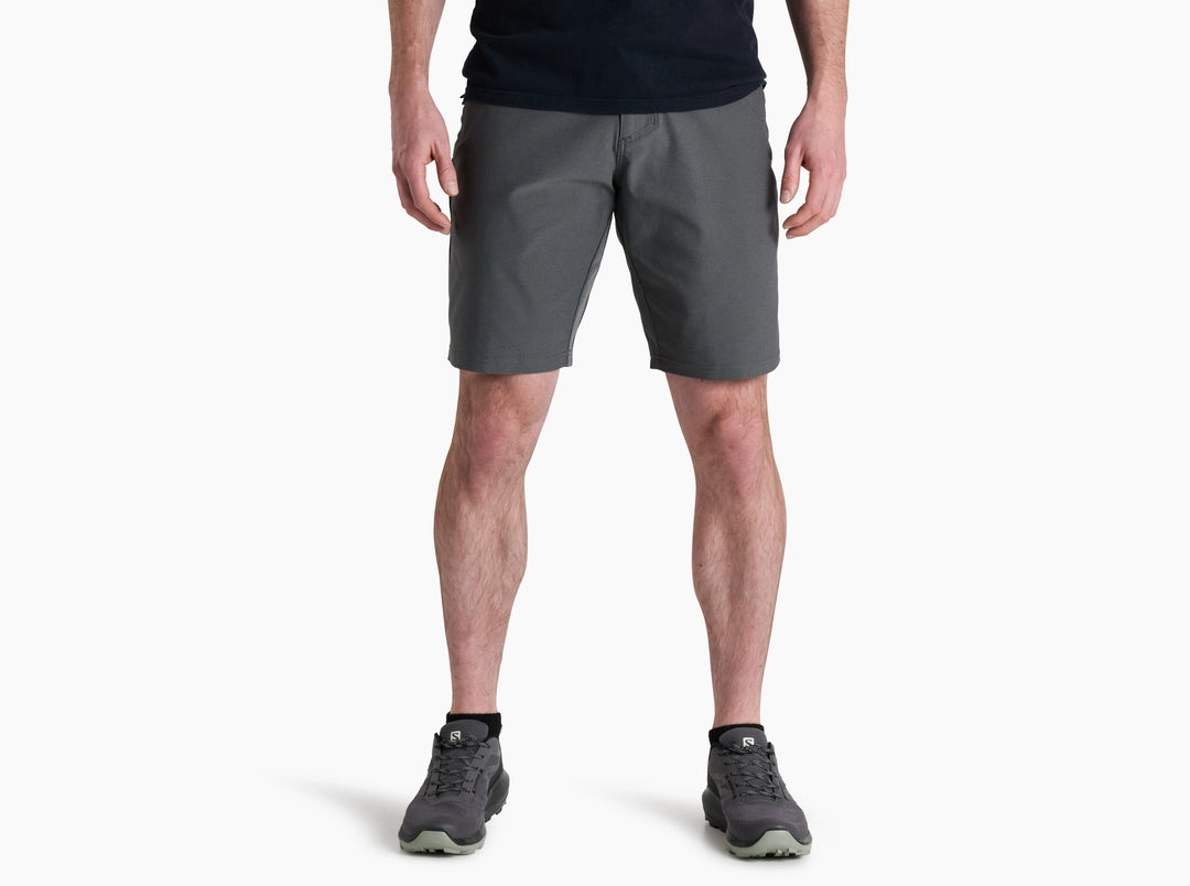 Person wearing gray shorts on a white background