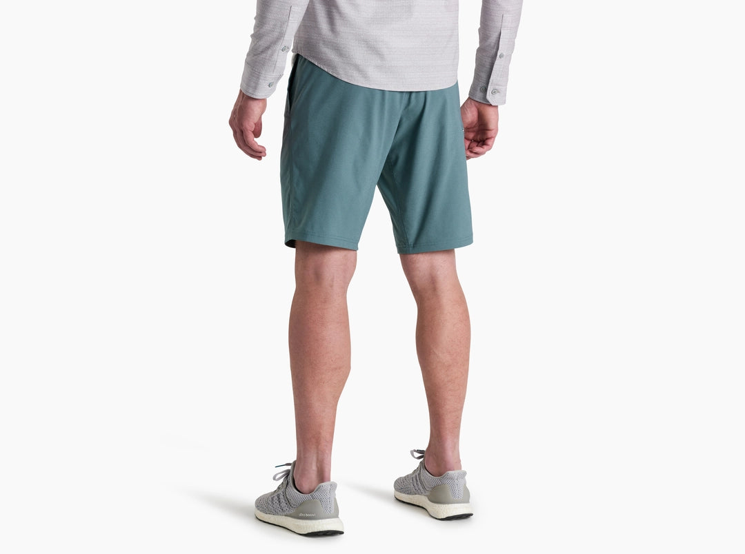 Person wearing teal shorts on a white background