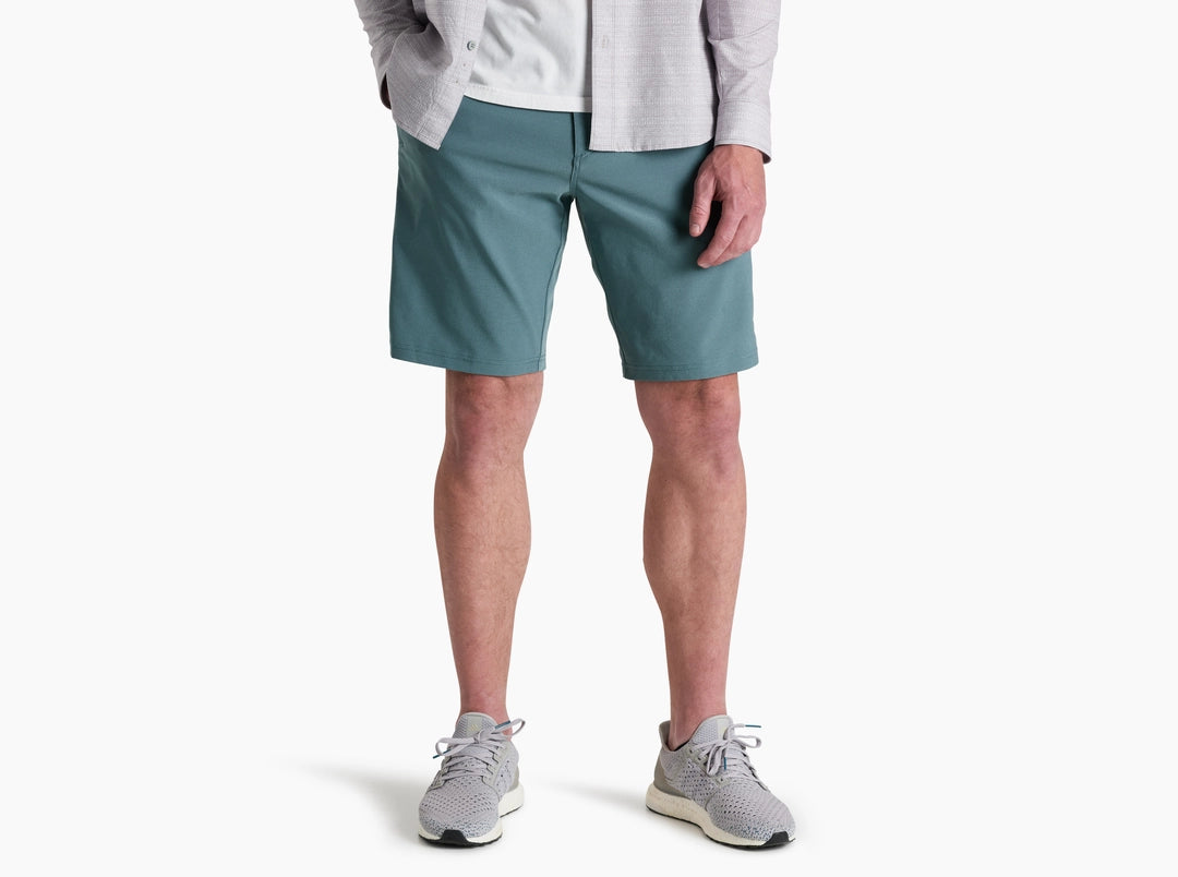 Person wearing teal shorts on a white background