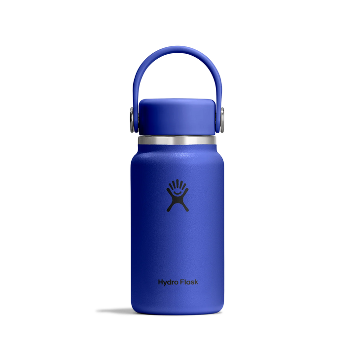A blue Hydro Flask water bottle with a matching blue lid and handle, featuring a silver metal band and the black Hydro Flask logo, shown on a clean white background.