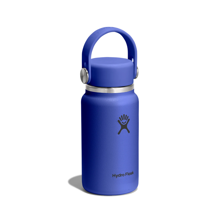 A Hydro Flask insulated water bottle in a vibrant blue color, featuring a matching blue lid with a carrying loop and a silver metal band, set against a plain white background.