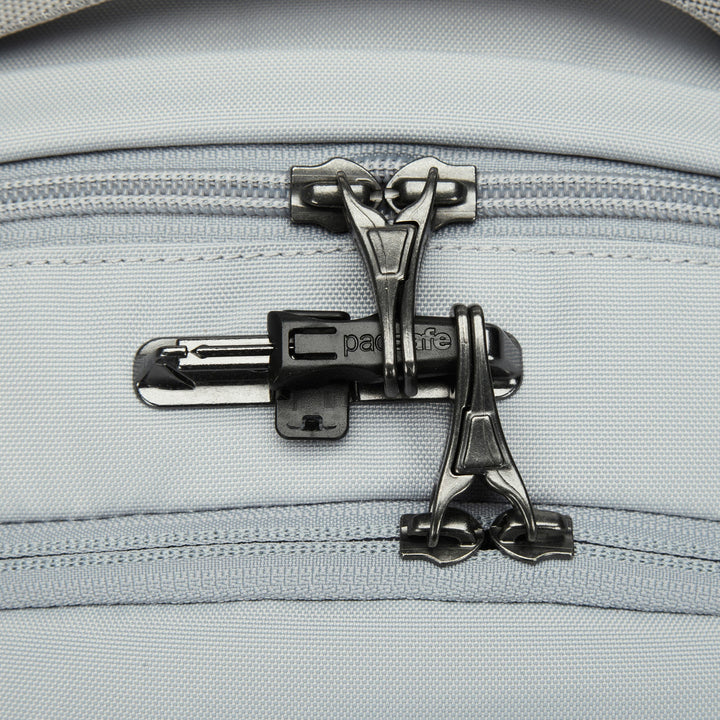 Close up of two zippers on top of a backpack showing the zip toggles clipped into a latch