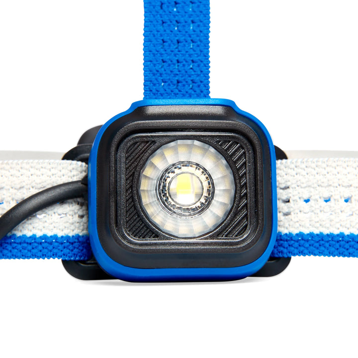 Close-up of a headlamp with blue strap on a white background