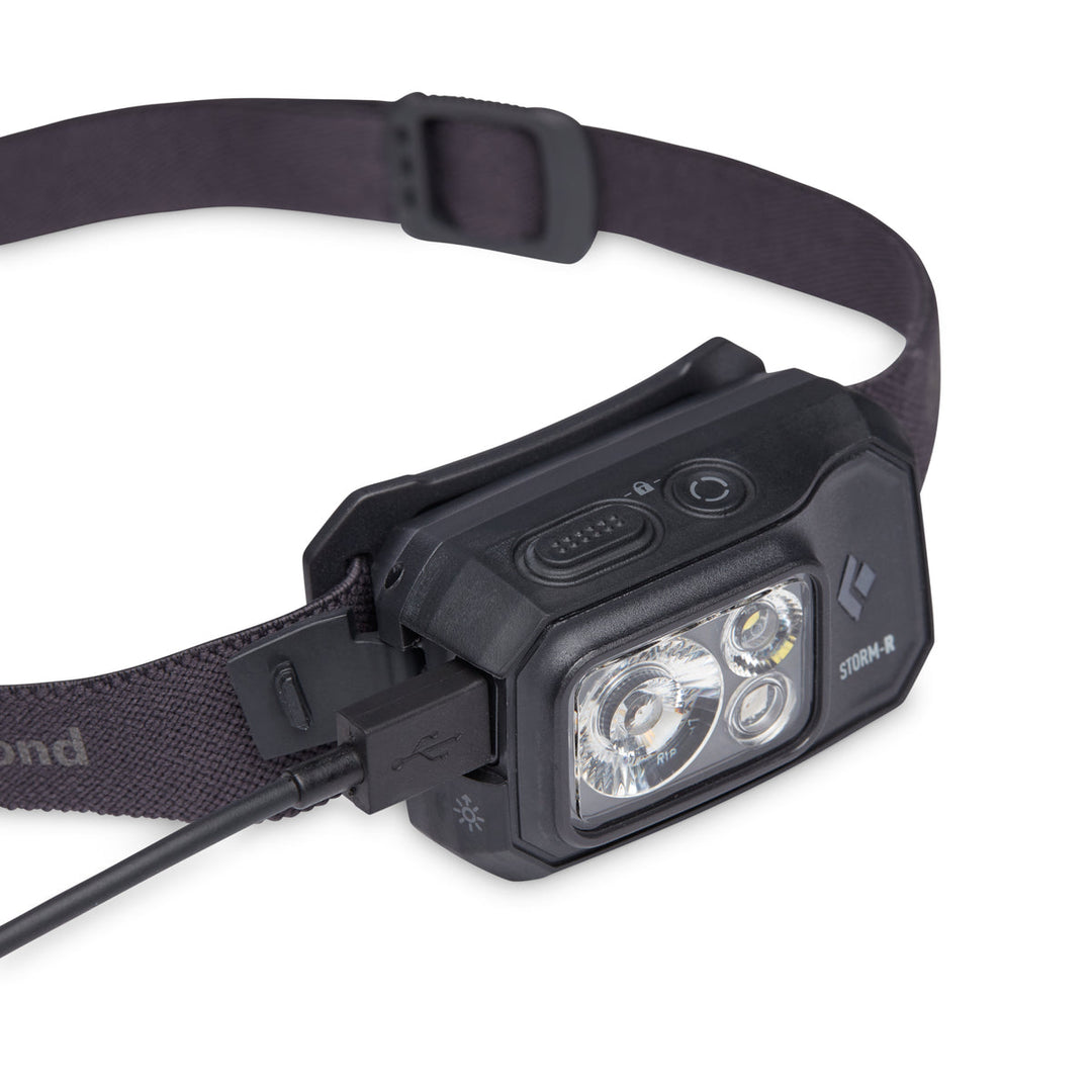 Black headlamp being charged via micro-USB