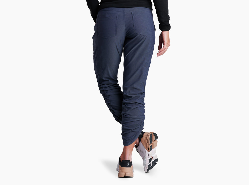 Person wearing Indigo pants on a white background.