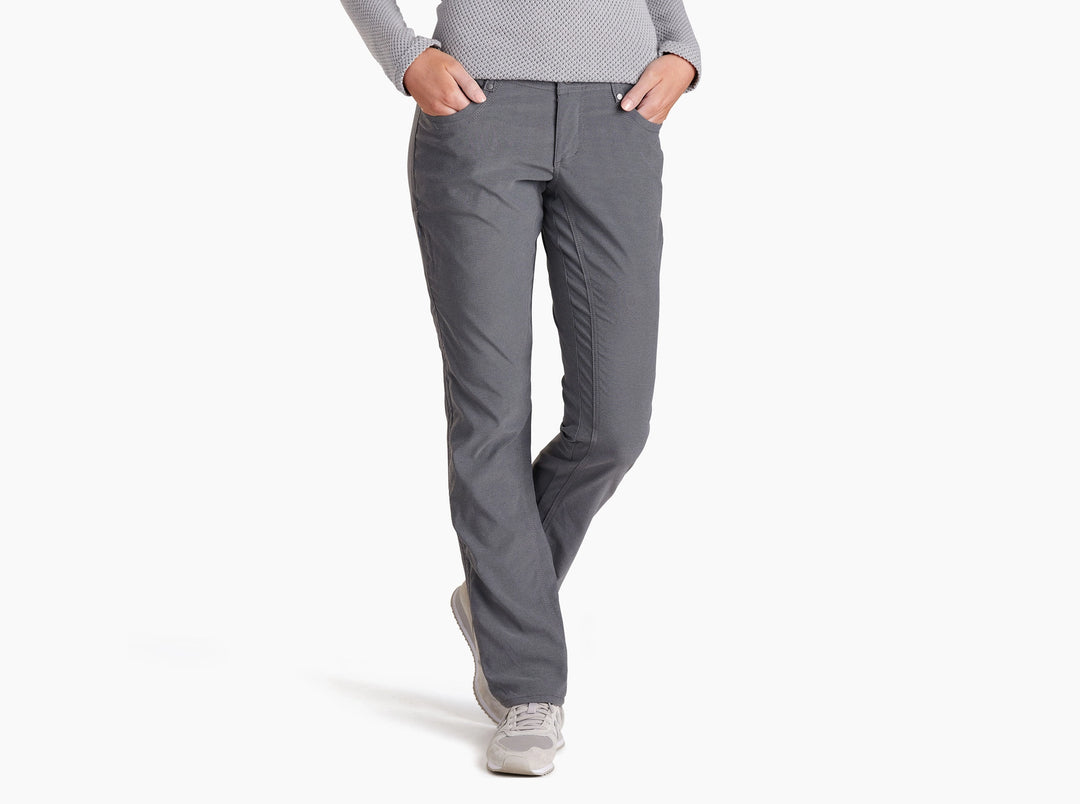 Person wearing charcoal coloured pants on a white background.