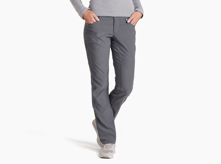 Person wearing charcoal coloured pants on a white background.