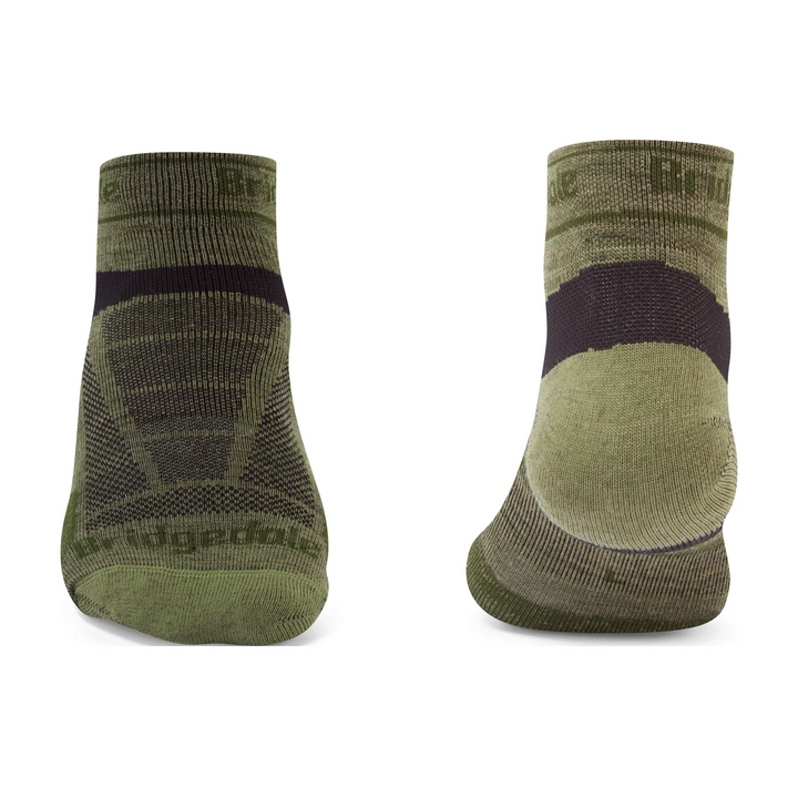 Pair of green socks with black accents on a white background