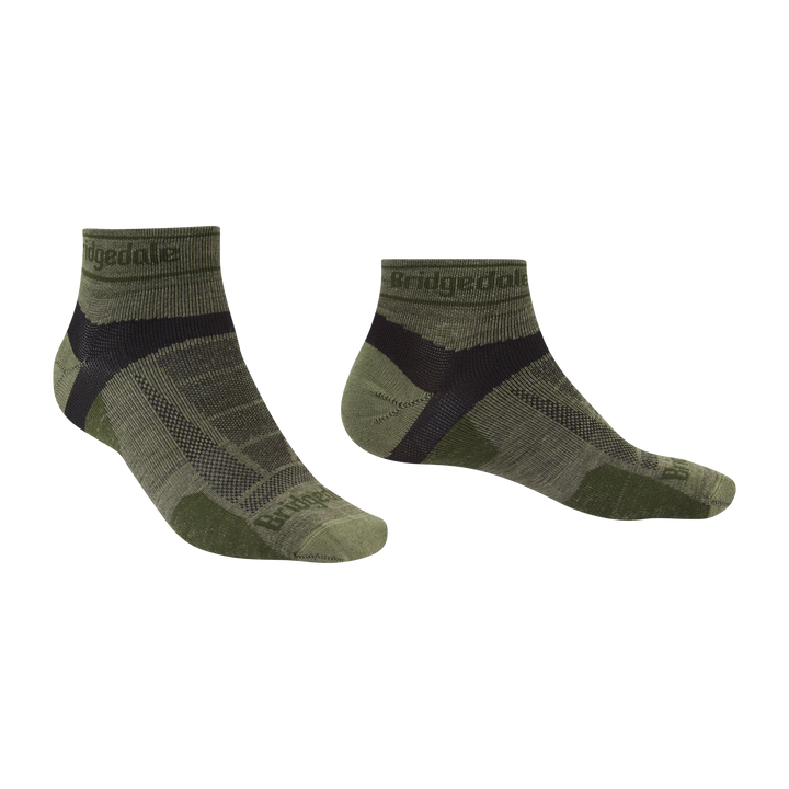 A pair of low-cut ankle socks in olive green and black, featuring the Bridgedale brand name printed on the cuff and toe area, displayed against a plain white background.