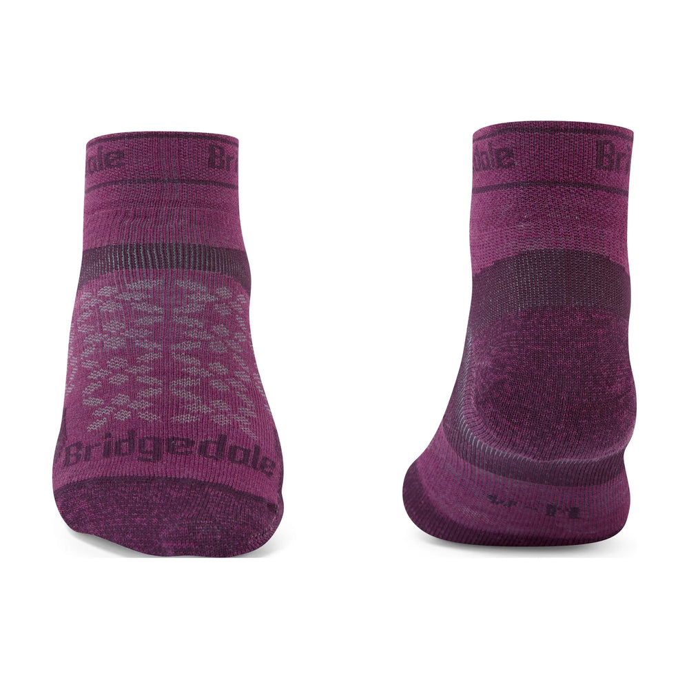 A pair of low-cut athletic socks shown from the front and back on a plain white background. The socks are heathered dark purple with darker purple accents on the heel, toe, and sole, and feature the 'Bridgedale' brand name printed on the front and cuff.