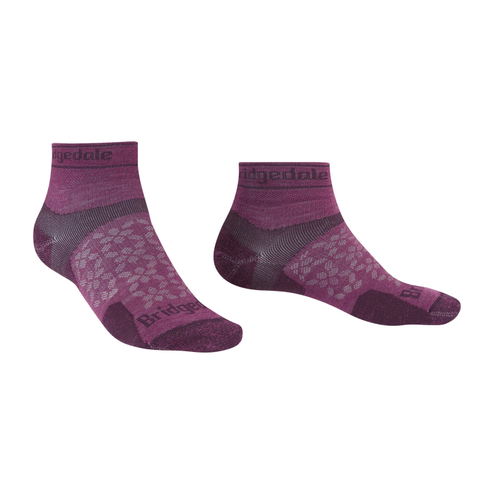 A pair of low-cut athletic socks in heathered purple and dark gray, featuring a textured pattern on the foot and the &