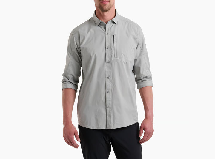Man wearing a light gray button-up shirt on a white background