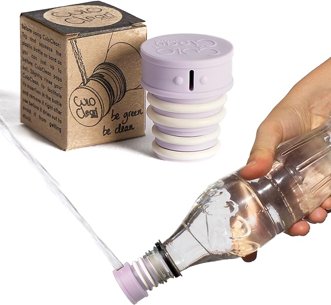 Lilac portable bidet screwed onto a plastic bottle and squirting water, packaging in background