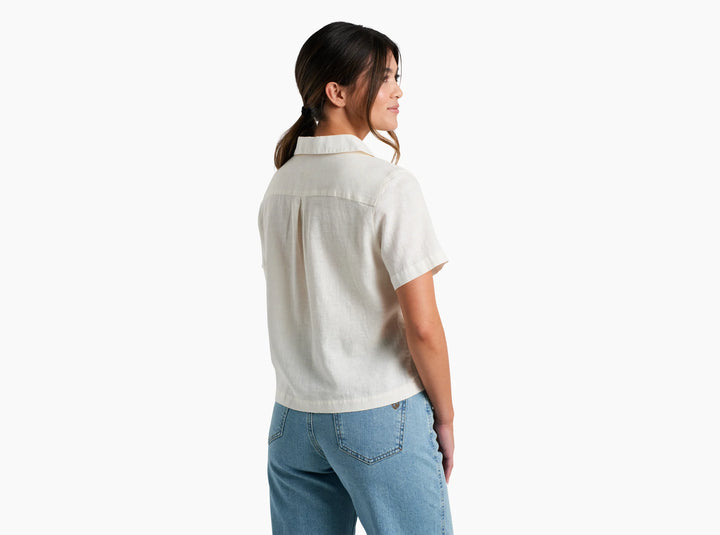 Woman wearing a white shirt and blue jeans on a white background