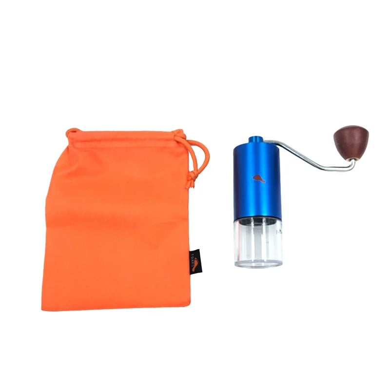 Blue metal hand coffee grinder next to an orange storage bag on a white background