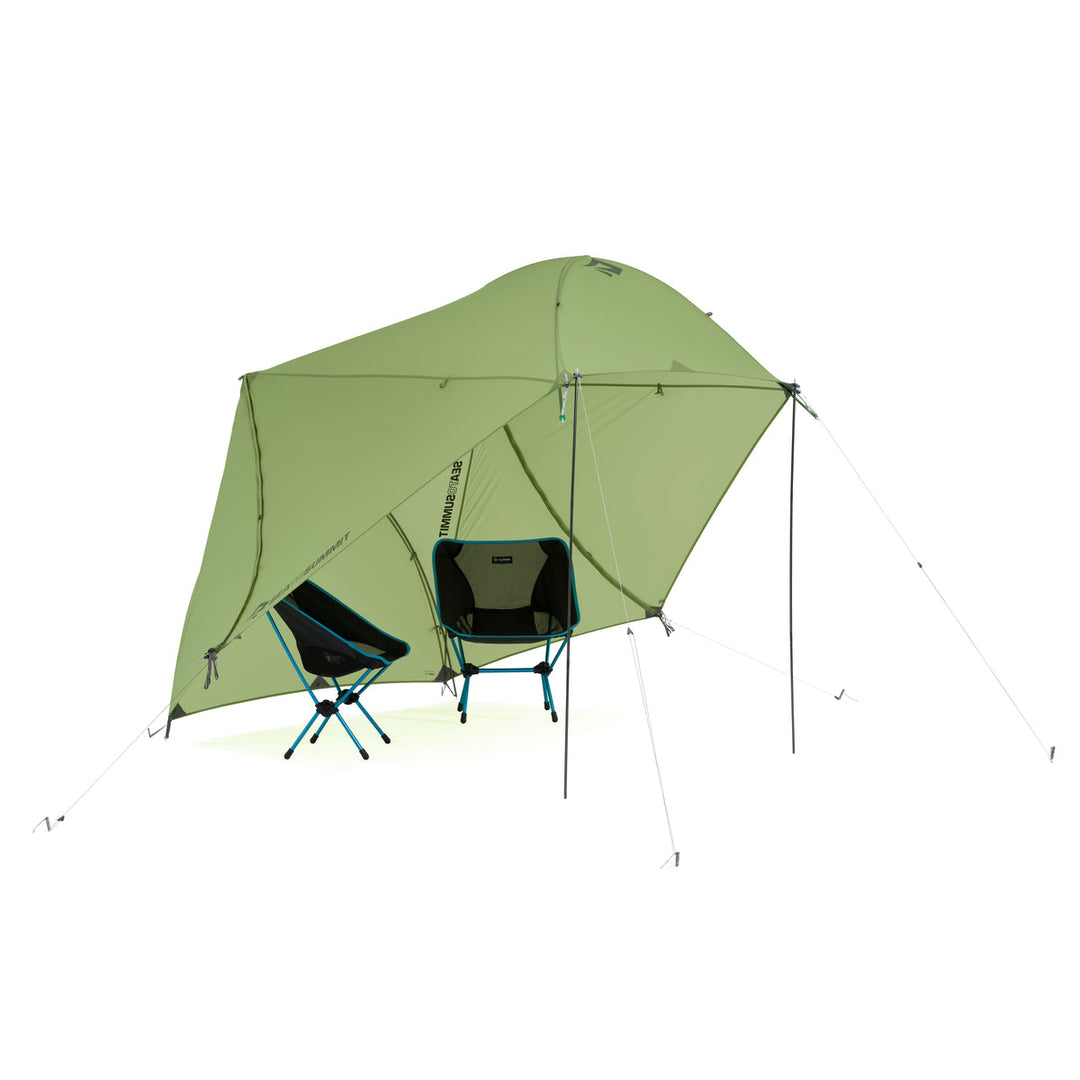 Green hiking tent fly set up a sun shade for two hiking chairs