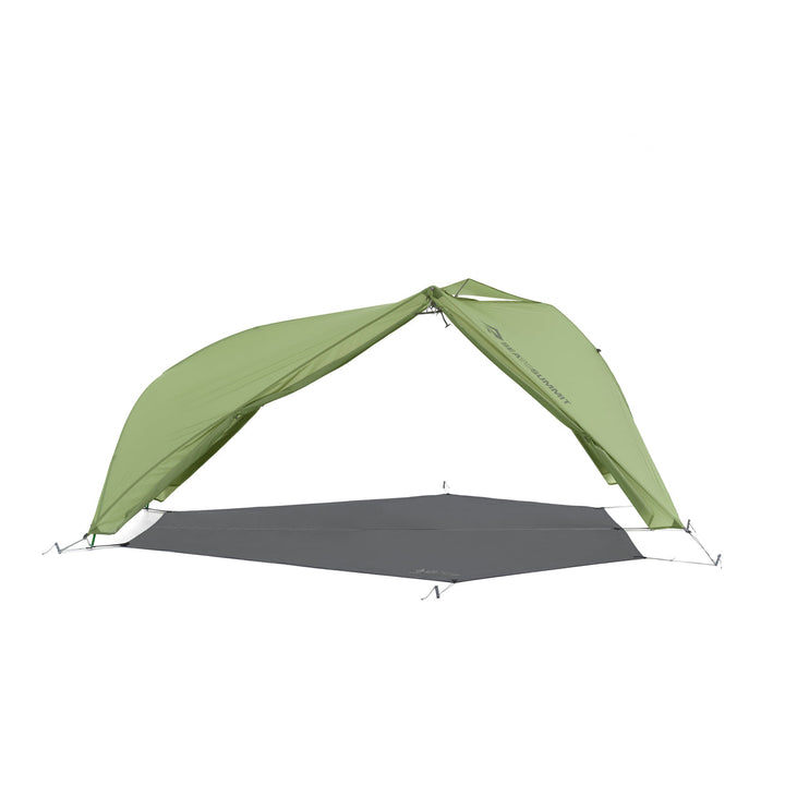 Green hiking tent fly pitched with footprint but no inner tent on a white background