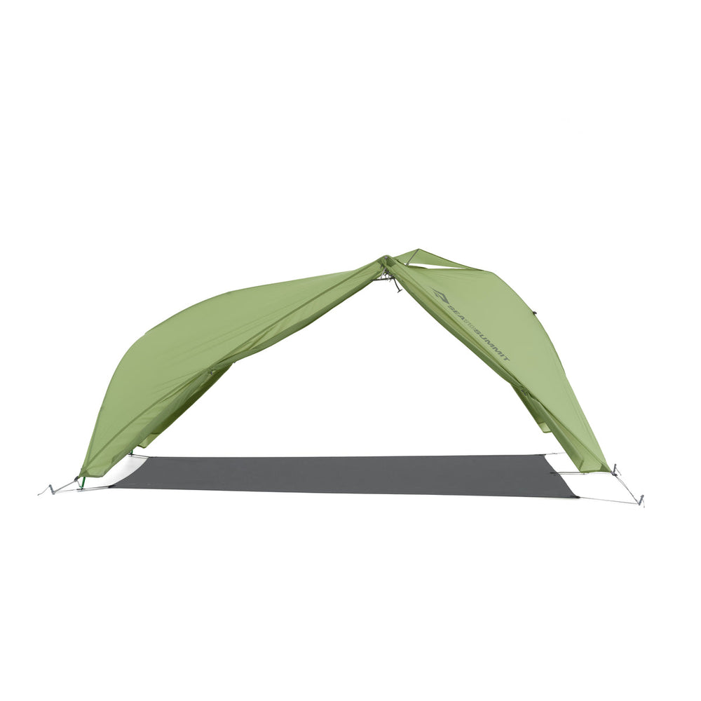 Green hiking tent fly pitched with a footprint but no inner tent on a white background