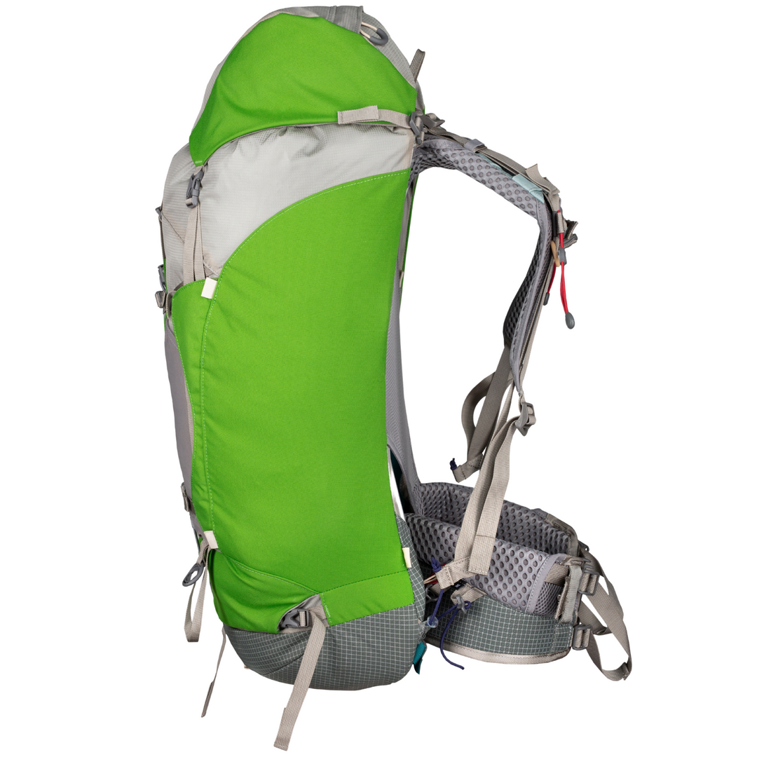 Green and grey hiking pack viewed in profile on a white background
