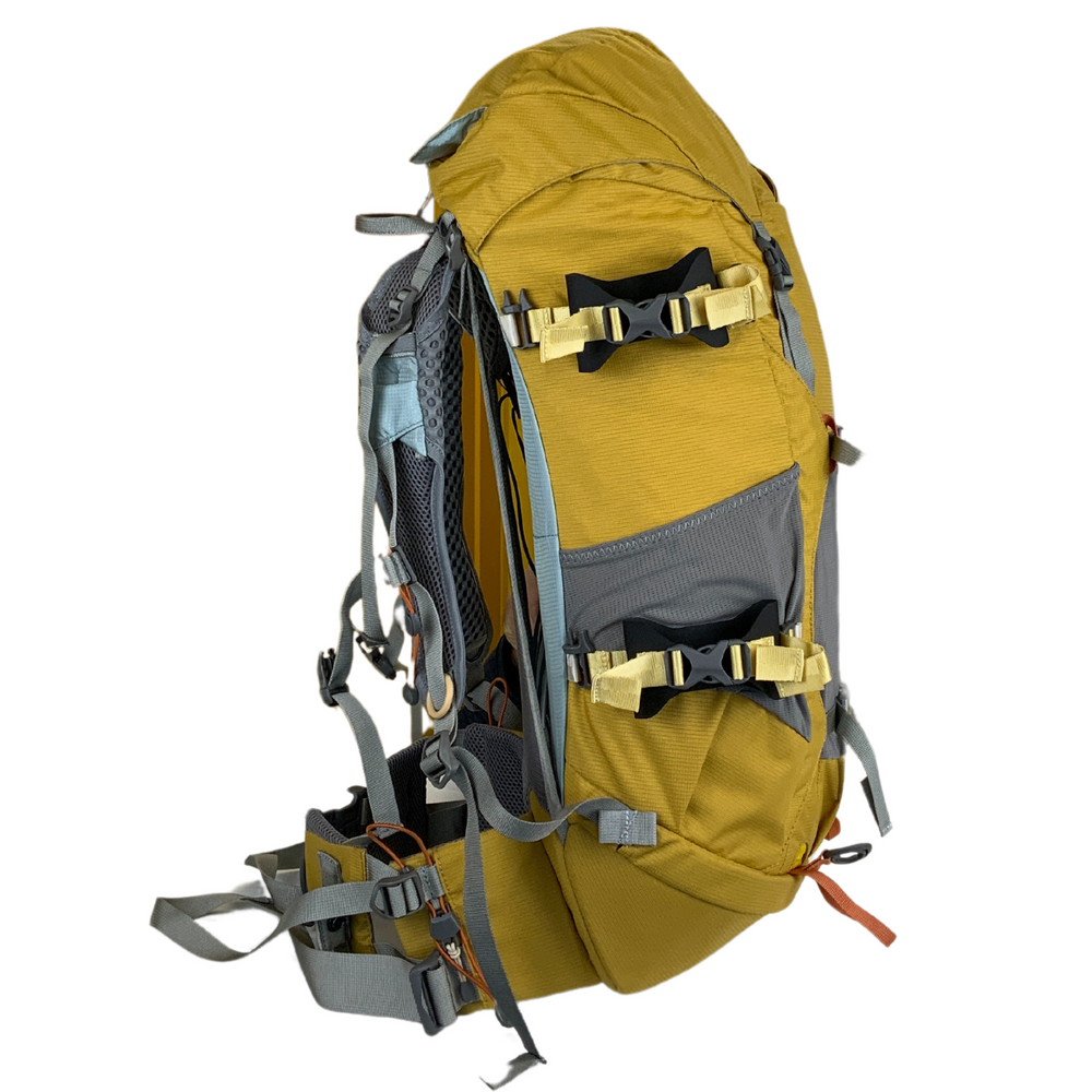 Yellow ski straps attached to the side of a yellow and gray Aarn backpack